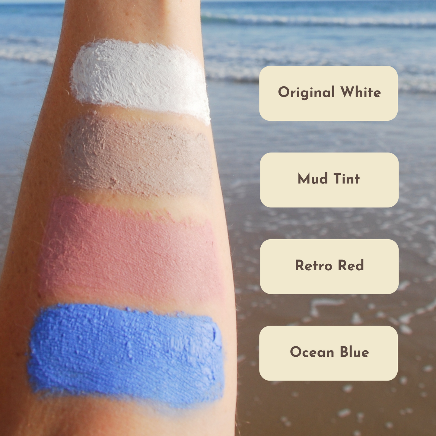 Closeup shot of an arm with a stripe of each colour Suntribe natural zinc sunscreen on. Next to each stripe is a text box with the name of each colour, From top to bottom they are Original white, Mud Tint, Retro red and Ocean Blue.